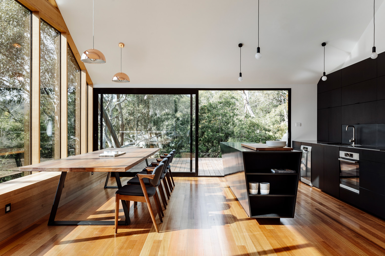 The Dark Exterior, That Recedes Amongst The Trees As Shadowy Form, Is Carried Through Internally To The Blackened Timber Kitche