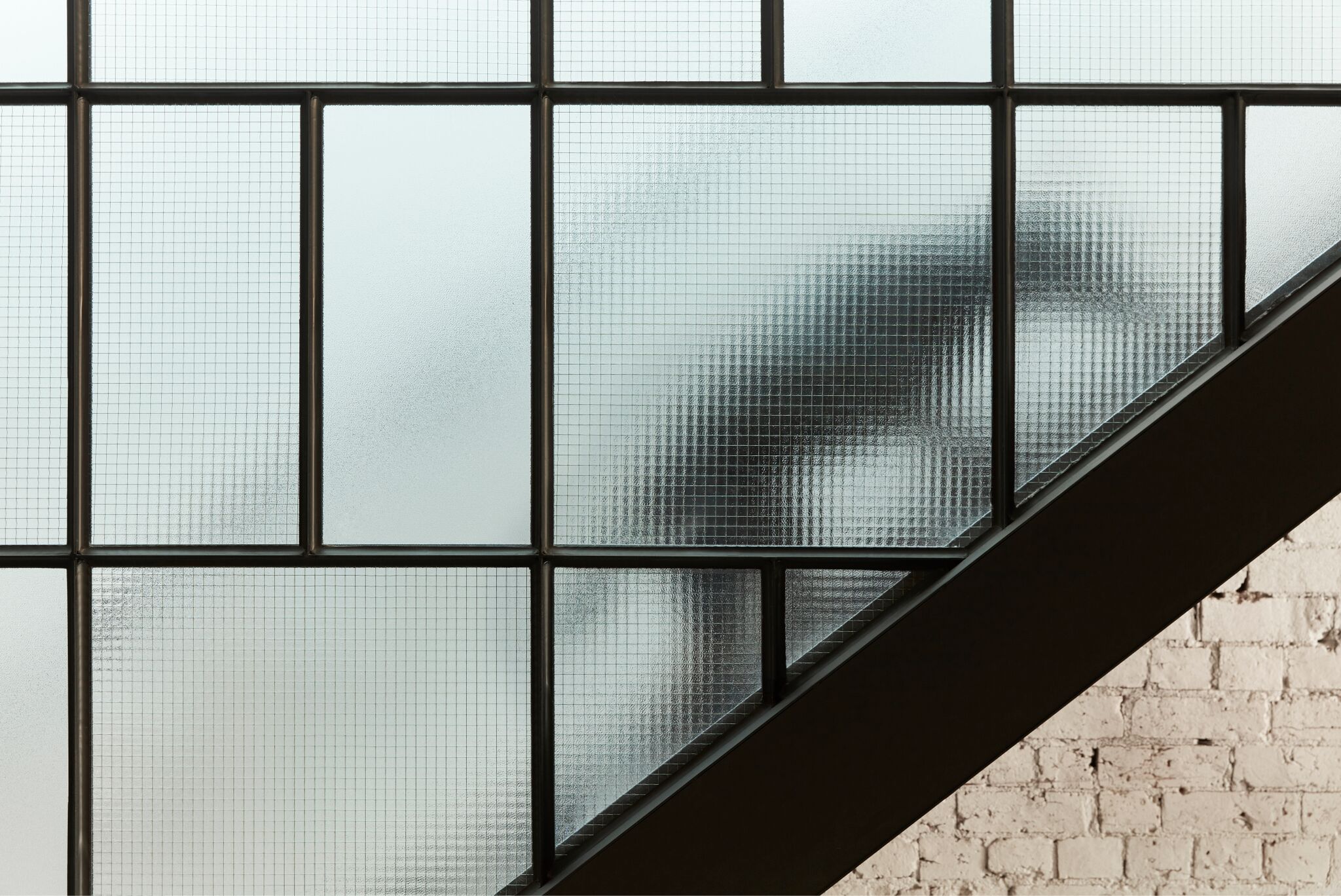 Subtle Curves And Brass Detail Of The Custom Kitchen.